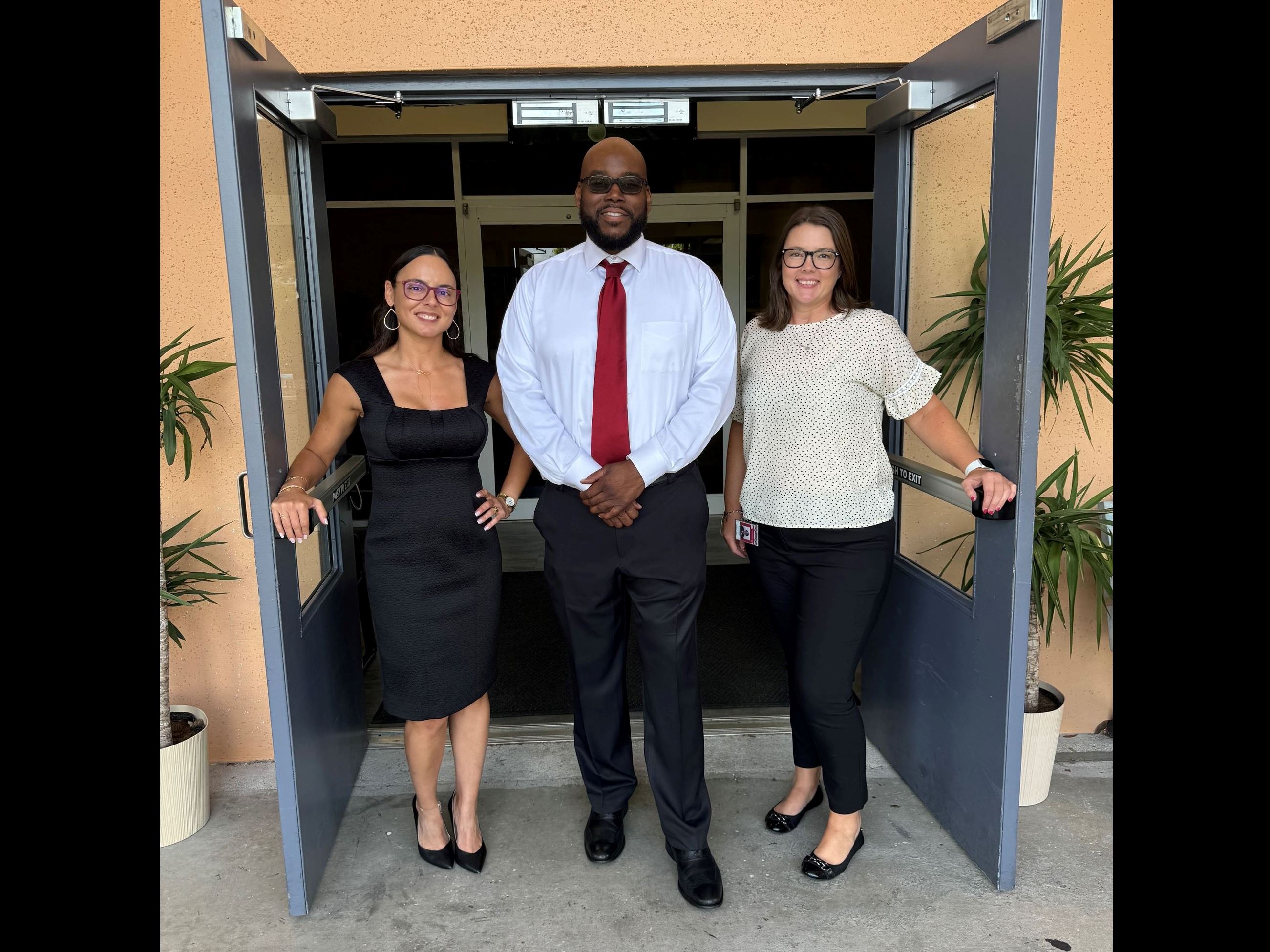 Dr. Garcia, Mr. Chance and Mrs. Torres standing in open doorway